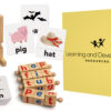 Decodable Wooden Blocks phonics toy with letter-matching cubes, illustrated word cards, and a wooden stand, designed for early literacy and reading skills.